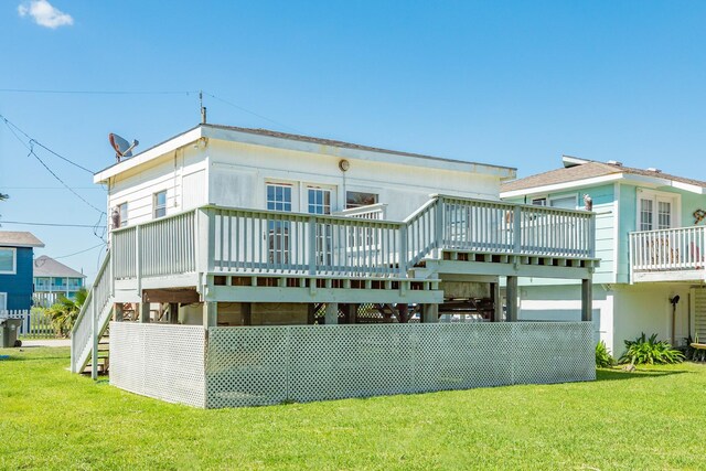11213 Schwartz Dr, Galveston, TX 77554 - rear view of house with a yard, stairway, and a deck