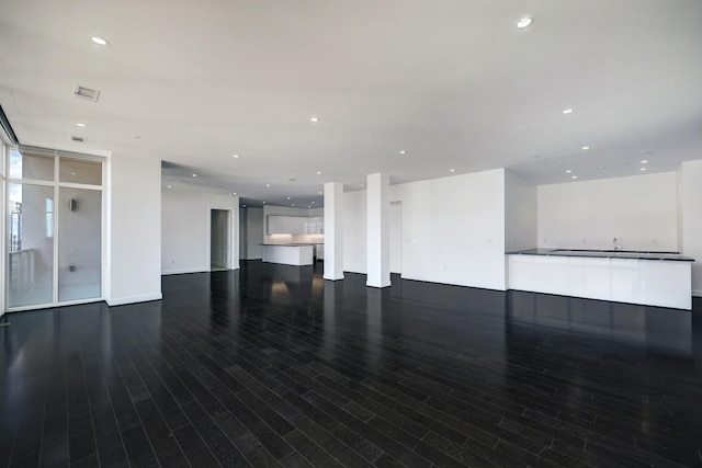 4521 San Felipe St Unit 2304-5, Houston, TX 77027 - unfurnished living room with visible vents, recessed lighting, and wood finished floors