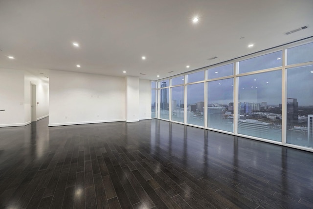4521 San Felipe St Unit 2304-5, Houston, TX 77027 - empty room featuring visible vents, baseboards, and wood finished floors