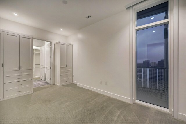 4521 San Felipe St Unit 2304-5, Houston, TX 77027 - unfurnished bedroom featuring baseboards, recessed lighting, and light colored carpet