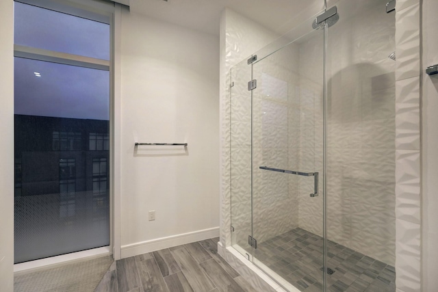 4521 San Felipe St Unit 2304-5, Houston, TX 77027 - bathroom with baseboards, wood finished floors, and a shower stall