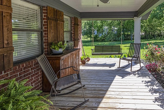 wooden deck with a yard and covered porch