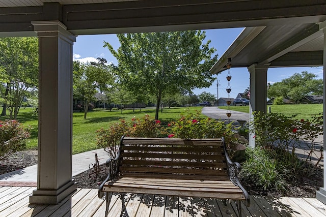 wooden deck featuring a lawn
