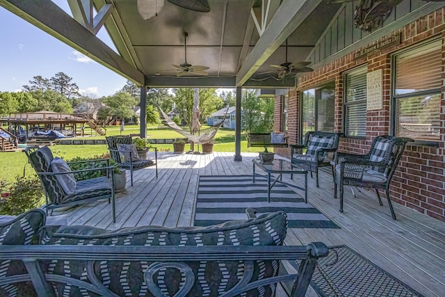 deck with a yard and ceiling fan