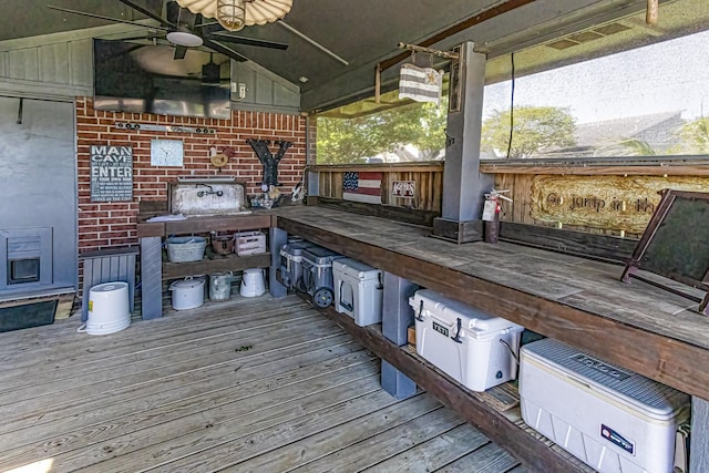 wooden terrace featuring a ceiling fan
