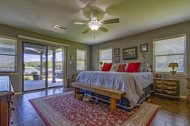 bedroom featuring access to exterior, baseboards, visible vents, ceiling fan, and wood-type flooring