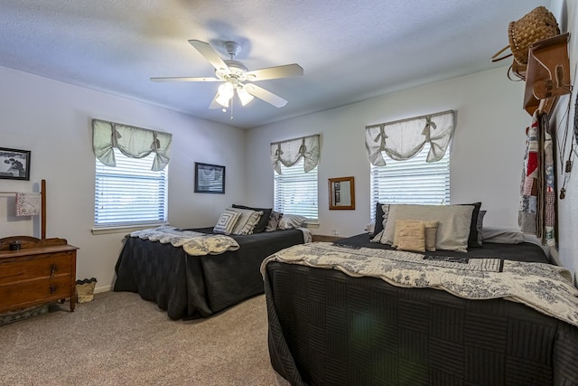 bedroom with light colored carpet, ceiling fan, and multiple windows