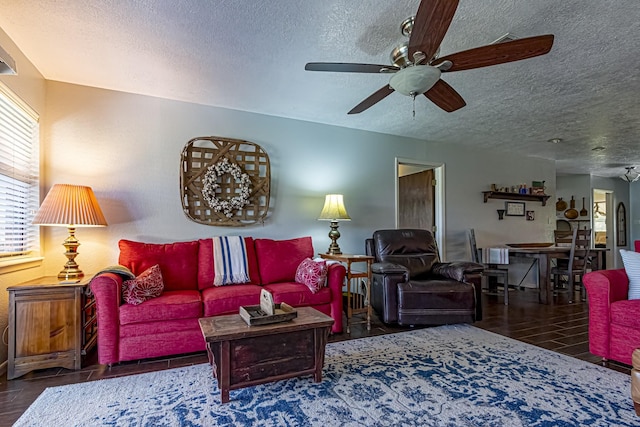 living area featuring ceiling fan, wood finished floors, and a textured ceiling