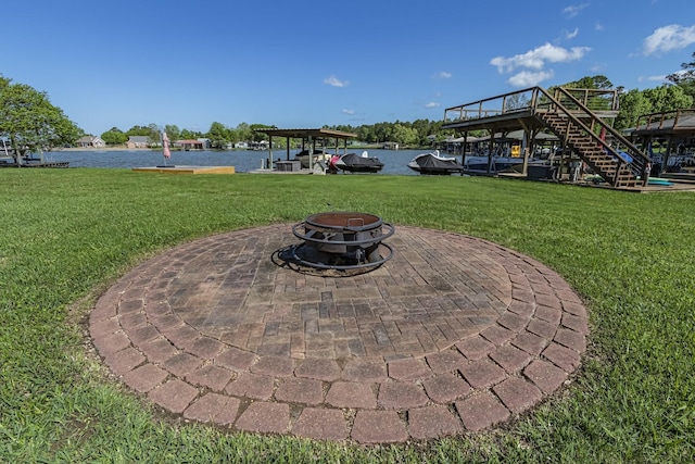 exterior space with a fire pit, a water view, and stairs