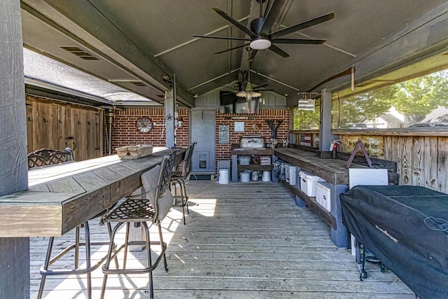 deck with ceiling fan, visible vents, and a bar
