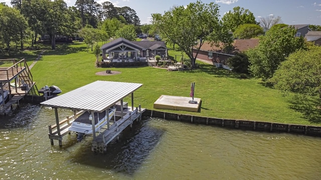 dock area featuring a yard, a water view, and boat lift