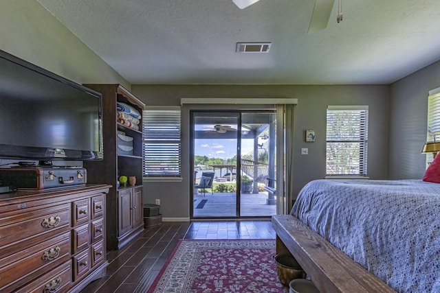 bedroom featuring a textured ceiling, visible vents, baseboards, access to outside, and wood tiled floor