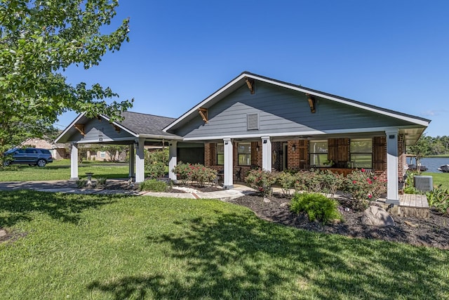 view of front of house featuring brick siding, a porch, and a front lawn