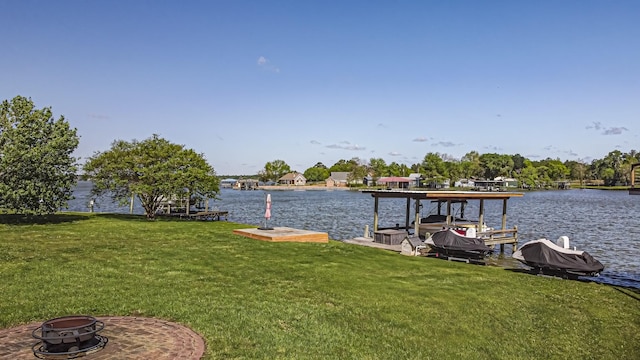 dock area with a fire pit, a lawn, and a water view