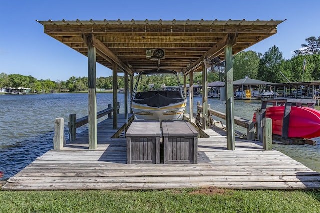 dock area with boat lift and a water view