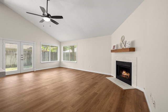 17311 Lowick St, Spring, TX 77379 - unfurnished living room with a fireplace with flush hearth, wood finished floors, french doors, baseboards, and ceiling fan
