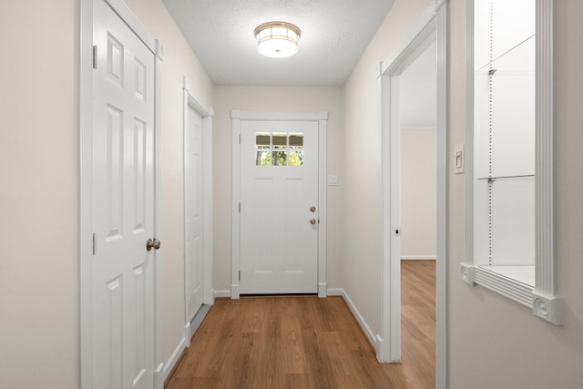 17311 Lowick St, Spring, TX 77379 - doorway with light wood-type flooring and baseboards