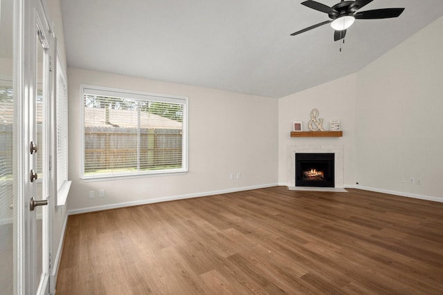 17311 Lowick St, Spring, TX 77379 - unfurnished living room with wood finished floors, lofted ceiling, ceiling fan, a fireplace with flush hearth, and baseboards