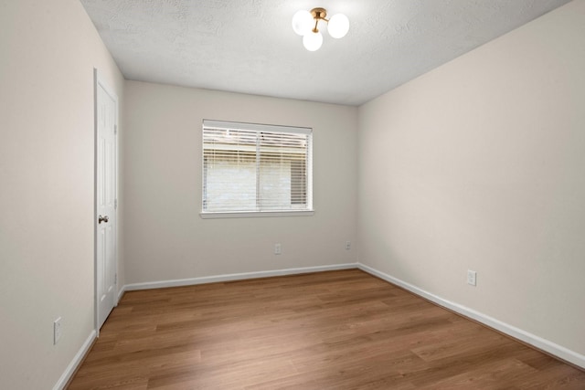 17311 Lowick St, Spring, TX 77379 - empty room with light wood-style floors, baseboards, and a textured ceiling