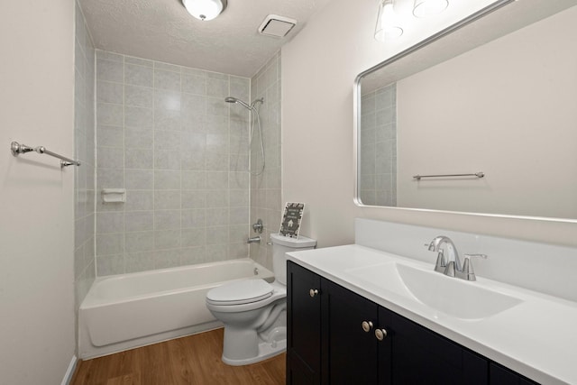 17311 Lowick St, Spring, TX 77379 - full bathroom with wood finished floors, toilet, bathtub / shower combination, vanity, and a textured ceiling