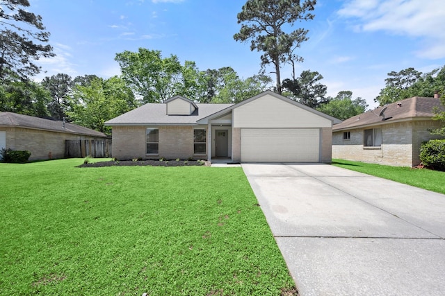 17311 Lowick St, Spring, TX 77379 - view of front of home with brick siding, a garage, driveway, and a front yard