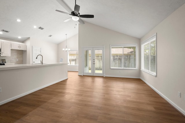 17311 Lowick St, Spring, TX 77379 - unfurnished living room featuring ceiling fan, healthy amount of natural light, recessed lighting, wood finished floors, and high vaulted ceiling