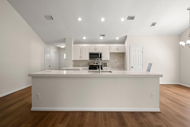 17311 Lowick St, Spring, TX 77379 - kitchen featuring stainless steel microwave, baseboards, wood finished floors, white cabinetry, and light countertops
