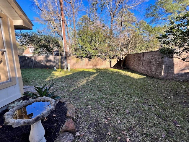 view of yard featuring a fenced backyard