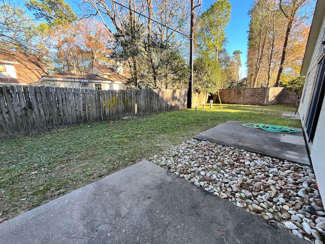 view of yard featuring a patio area and a fenced backyard