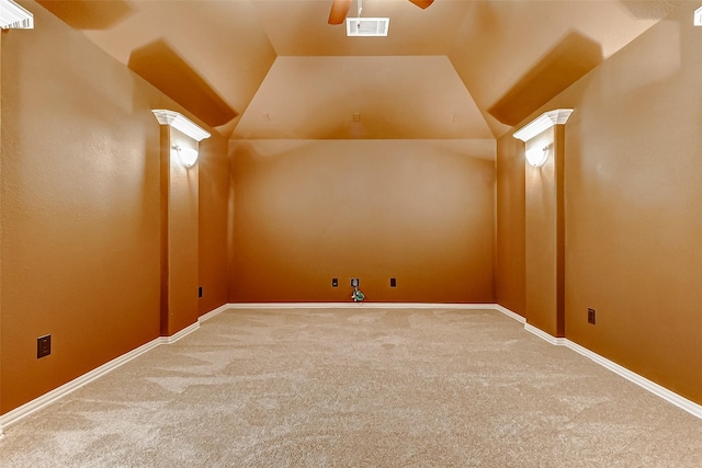 interior space featuring carpet, visible vents, lofted ceiling, and ceiling fan