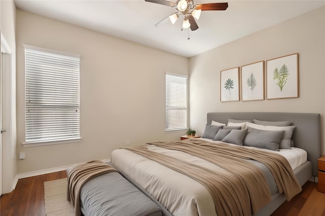 bedroom featuring ceiling fan, baseboards, and wood finished floors