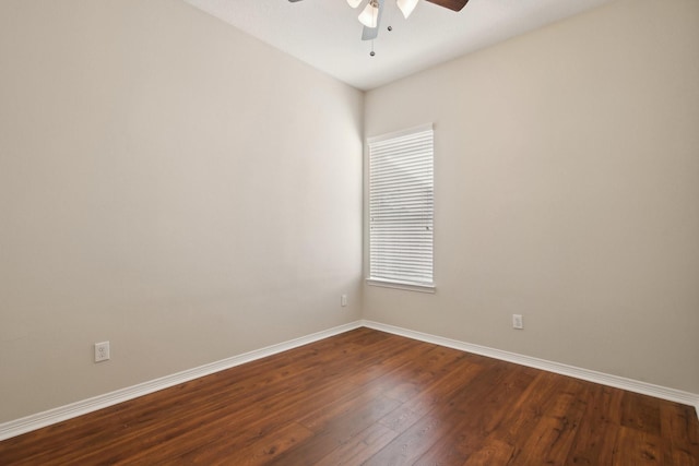 unfurnished room featuring baseboards, a ceiling fan, and dark wood-style floors
