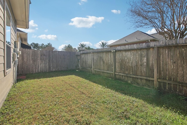 view of yard with a fenced backyard