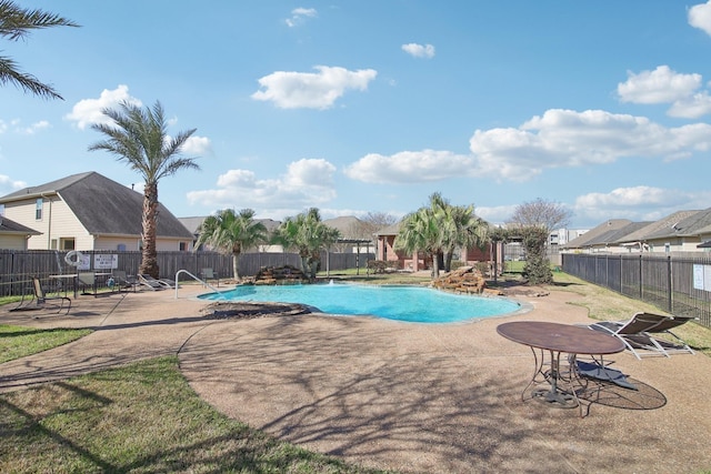 pool with a patio and fence
