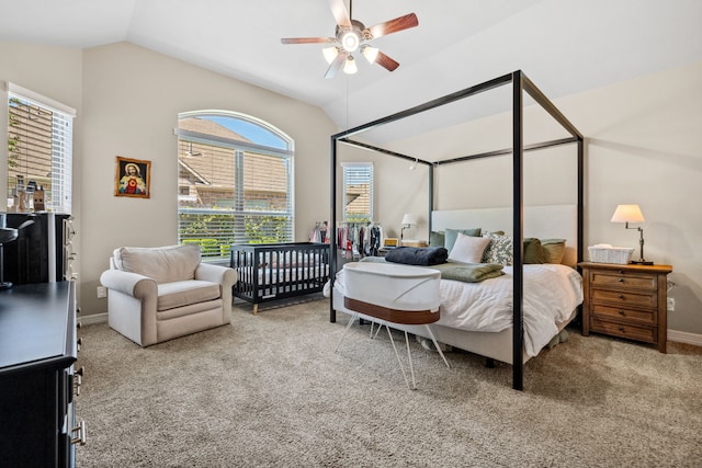 carpeted bedroom with baseboards, a ceiling fan, and vaulted ceiling