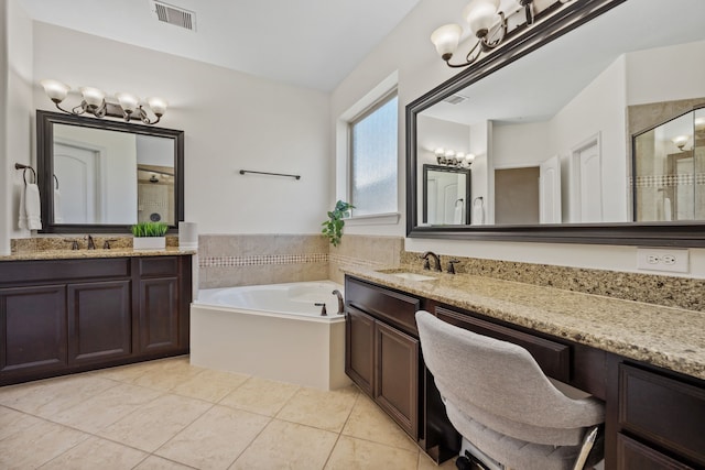 full bathroom featuring an inviting chandelier, visible vents, a shower stall, and a sink