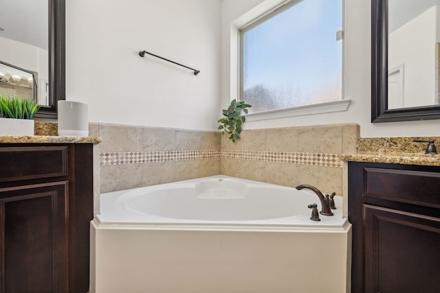 bathroom featuring vanity and a garden tub