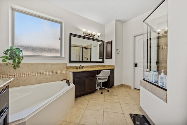 bathroom featuring a bath, a shower stall, vanity, and a healthy amount of sunlight