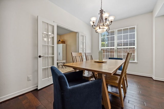 dining room with dark wood-type flooring, baseboards, and a notable chandelier