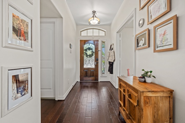 entryway with baseboards and dark wood finished floors