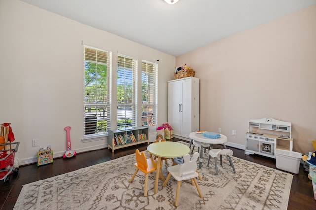 game room with dark wood-style flooring and baseboards