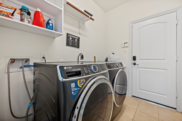 laundry area featuring independent washer and dryer, light tile patterned floors, and laundry area