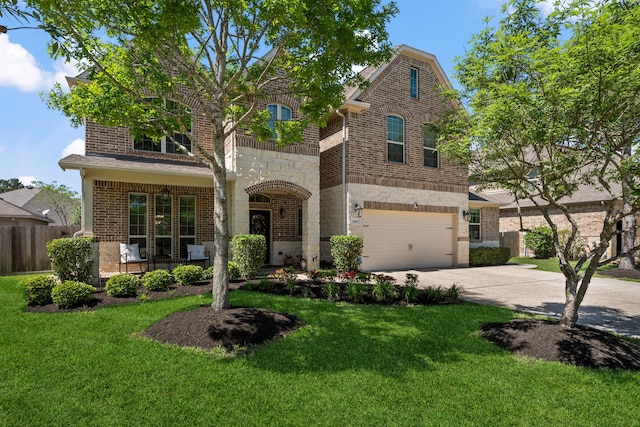 view of front of house with a front yard, brick siding, driveway, and fence
