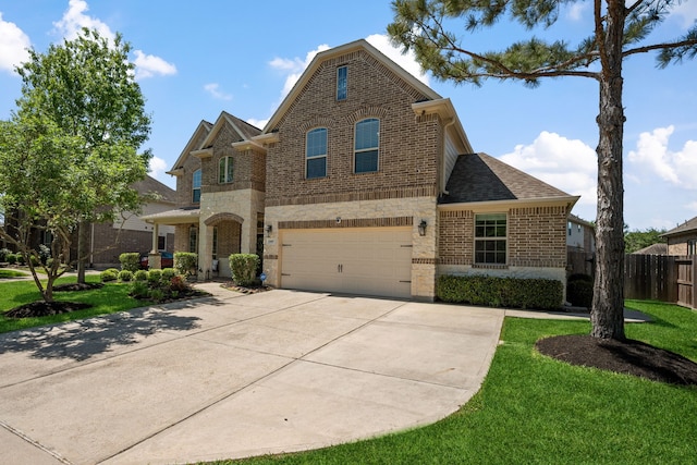 traditional-style home featuring a garage, a front yard, fence, brick siding, and concrete driveway