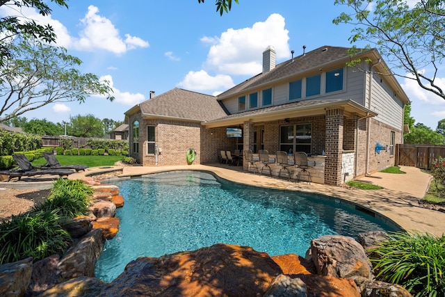 view of swimming pool with a fenced in pool, a patio, outdoor dry bar, a gate, and fence