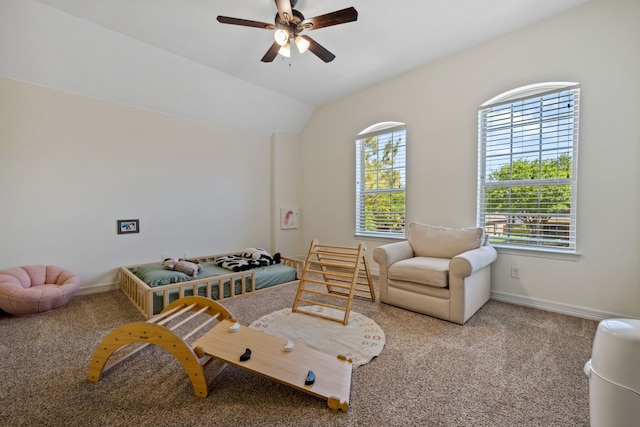 living area with baseboards, a ceiling fan, and carpet