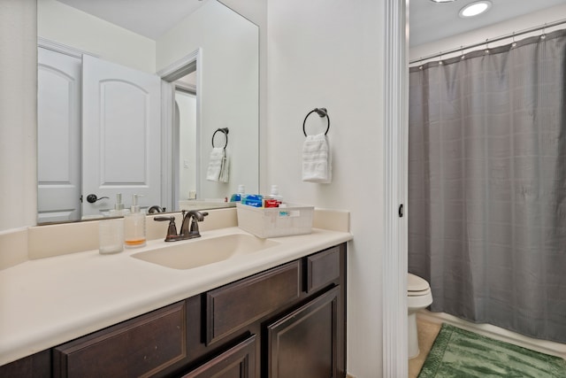 bathroom with toilet, vanity, and a shower with curtain