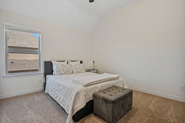 carpeted bedroom with ceiling fan, baseboards, and lofted ceiling