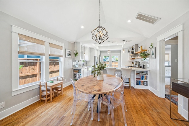 dining area featuring visible vents, baseboards, light wood-style floors, recessed lighting, and vaulted ceiling