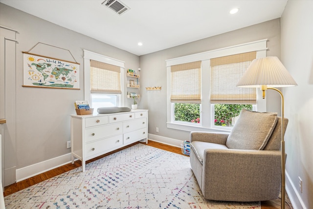 sitting room featuring recessed lighting, wood finished floors, visible vents, and baseboards